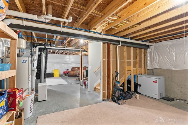 1621 Stonebury Ct, Xenia, OH 45385 - unfinished below grade area featuring fridge, stairway, and water heater