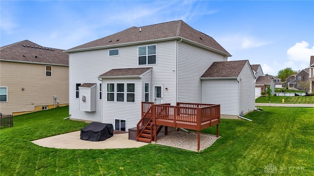 1621 Stonebury Ct, Xenia, OH 45385 - rear view of house with a patio area, a wooden deck, a lawn, and roof with shingles