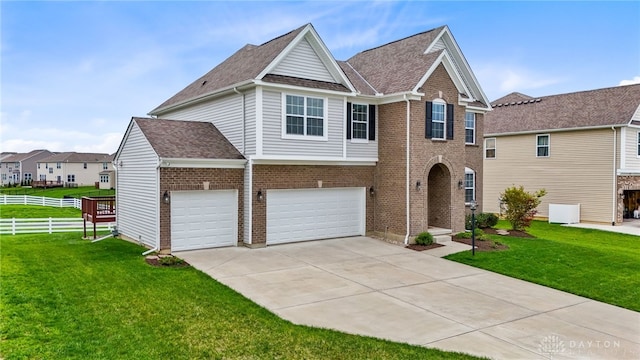 1621 Stonebury Ct, Xenia, OH 45385 - view of front facade featuring driveway, an attached garage, brick siding, and a shingled roof