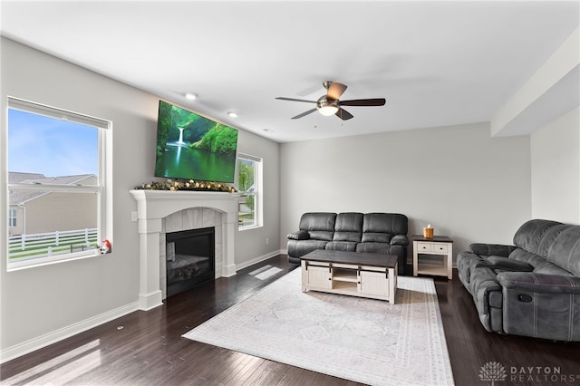 1621 Stonebury Ct, Xenia, OH 45385 - living area featuring ceiling fan, hardwood / wood-style floors, a glass covered fireplace, and baseboards