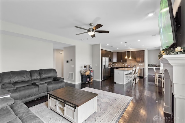 1621 Stonebury Ct, Xenia, OH 45385 - living area with a ceiling fan, recessed lighting, dark wood finished floors, and baseboards
