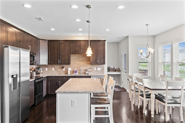 1621 Stonebury Ct, Xenia, OH 45385 - kitchen featuring appliances with stainless steel finishes, a sink, dark brown cabinets, recessed lighting, and decorative backsplash