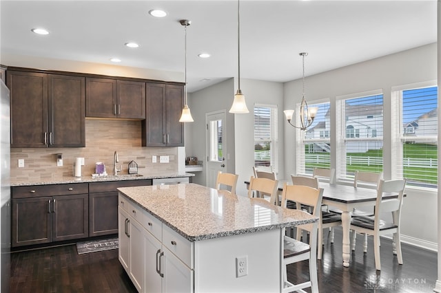 1621 Stonebury Ct, Xenia, OH 45385 - kitchen featuring a sink, dark wood-style floors, plenty of natural light, dark brown cabinetry, and recessed lighting