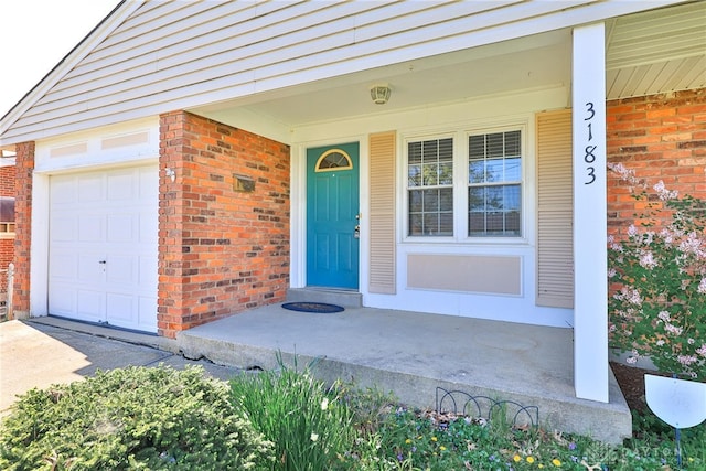 property entrance featuring a porch and brick siding