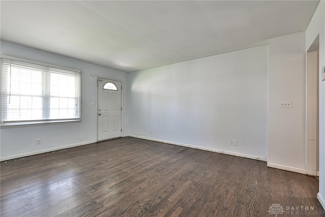 entryway featuring baseboards, wood finished floors, and visible vents