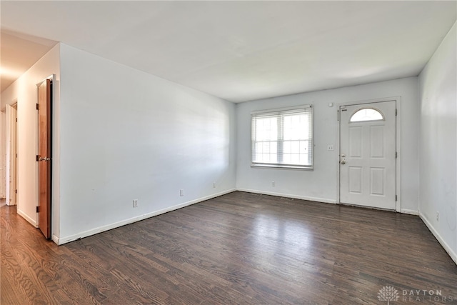 entryway with dark wood-style flooring and baseboards