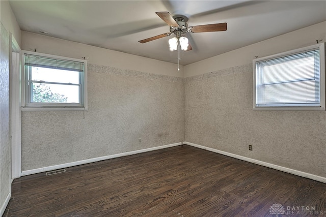 empty room featuring baseboards and wood finished floors