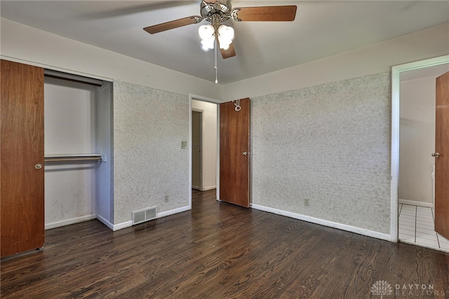 unfurnished bedroom with baseboards, a ceiling fan, wood finished floors, and visible vents