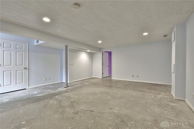 finished basement with recessed lighting, baseboards, visible vents, and a textured ceiling