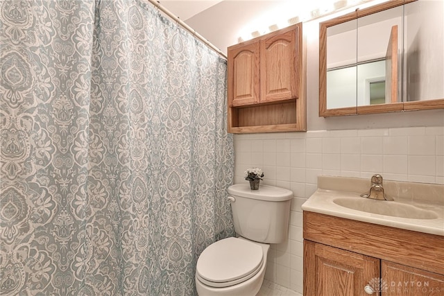 full bathroom with tile walls, vanity, toilet, and curtained shower