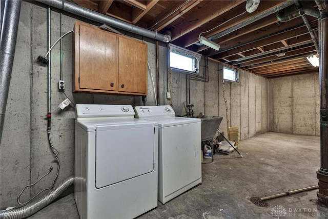 washroom with cabinet space and washer and dryer