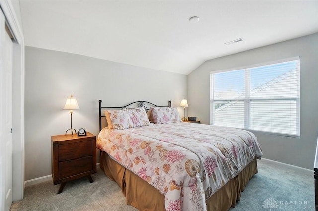 bedroom featuring baseboards, vaulted ceiling, light carpet, and visible vents