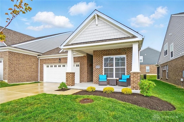 view of front of house featuring brick siding, a garage, a front yard, and concrete driveway
