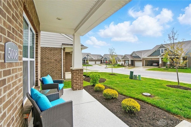 view of patio / terrace with a porch and a residential view