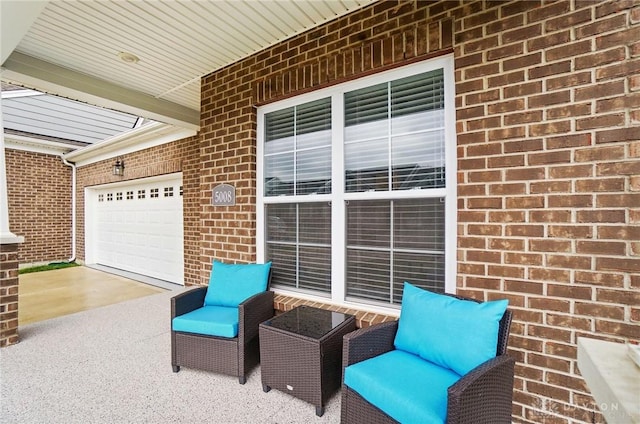 view of patio featuring a garage and driveway