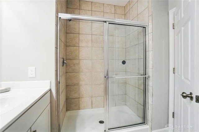 bathroom featuring vanity and a stall shower
