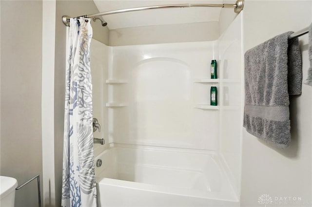 full bath with toilet and shower / bath combo with shower curtain