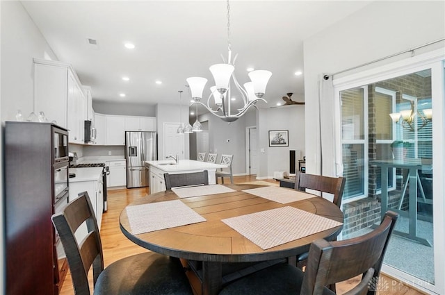 dining area with recessed lighting, a chandelier, and light wood-style floors