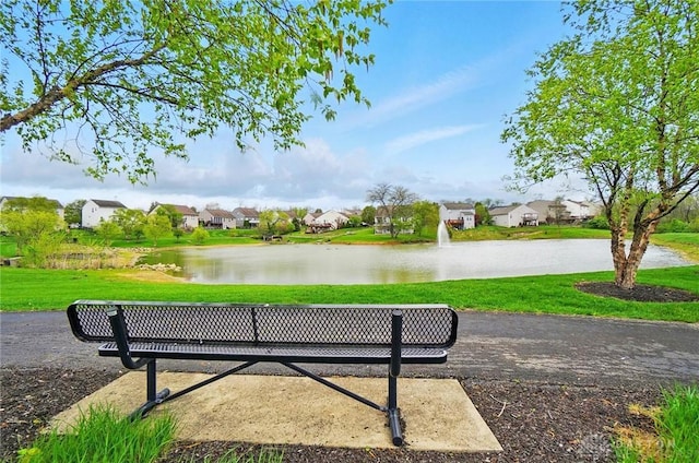 view of community with a water view, a yard, and a residential view