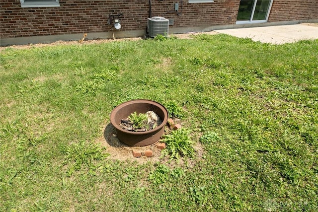 exterior details featuring cooling unit and brick siding