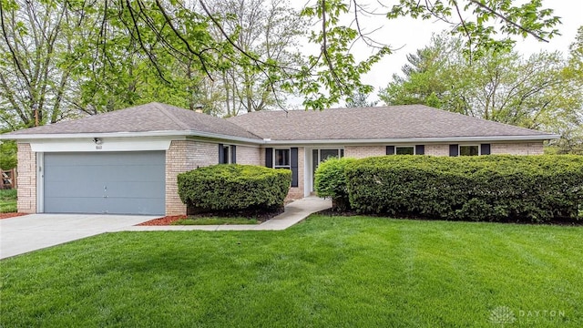 single story home featuring a front lawn, brick siding, a shingled roof, an attached garage, and driveway