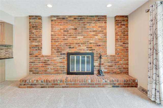 room details with carpet flooring, recessed lighting, a brick fireplace, and visible vents