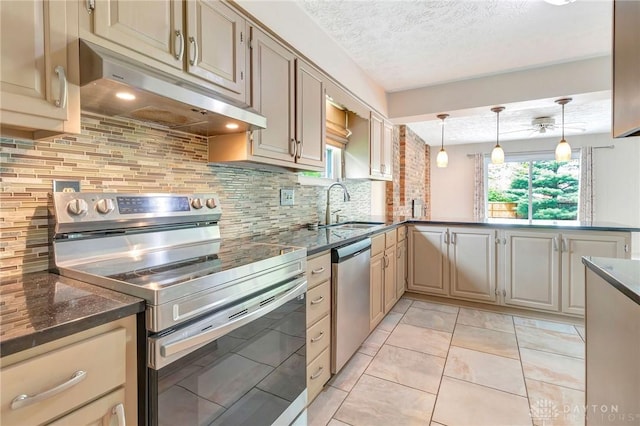 kitchen with decorative backsplash, a peninsula, under cabinet range hood, a sink, and stainless steel appliances