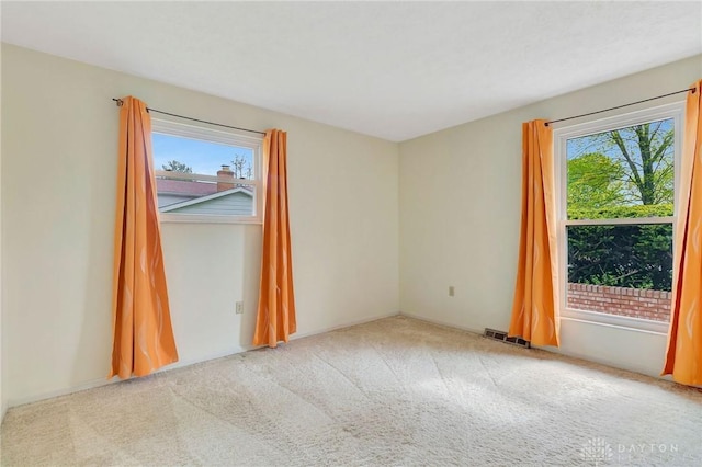 empty room with visible vents and carpet