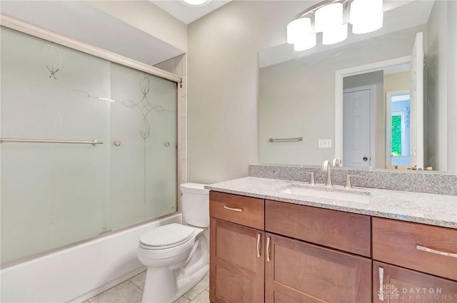 full bathroom featuring shower / bath combination with glass door, toilet, tile patterned flooring, and vanity