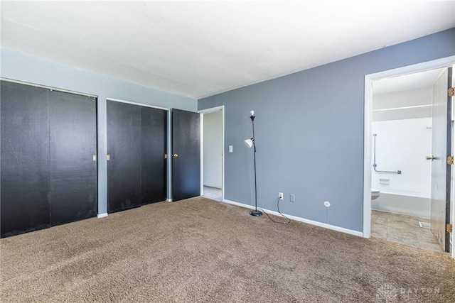 5675 E Coach Dr Unit B, Kettering, OH 45440 - unfurnished bedroom with carpet floors, two closets, baseboards, and connected bathroom