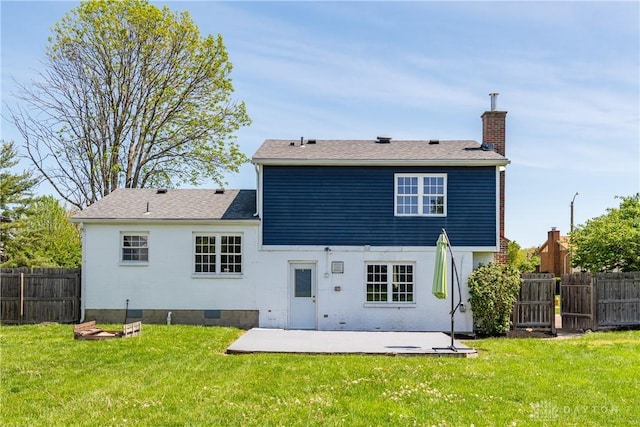 rear view of house with a lawn, a patio area, fence, and a chimney