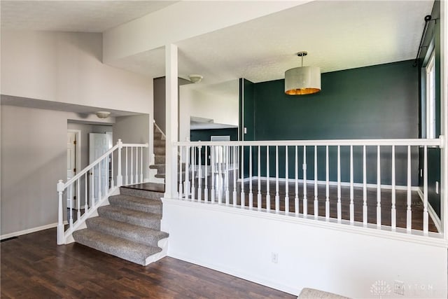 stairs featuring baseboards and wood finished floors