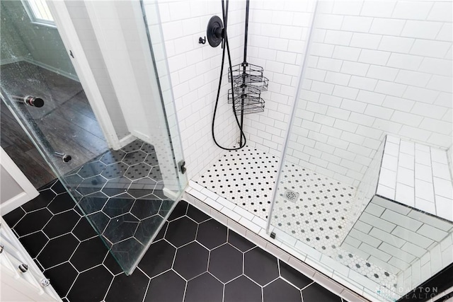 full bathroom featuring tile patterned floors and a shower stall