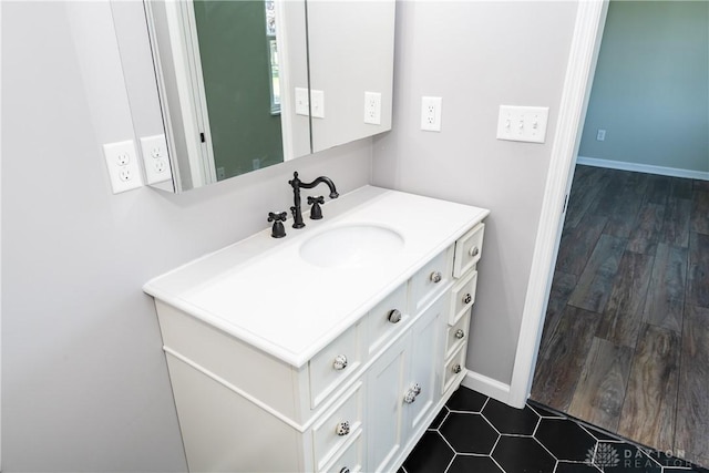 bathroom with vanity and baseboards