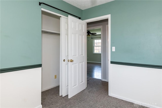 unfurnished bedroom featuring baseboards, carpet, and a closet