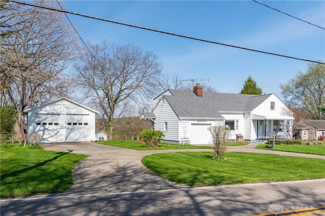 view of front of property featuring a chimney, roof with shingles, a garage, an outdoor structure, and a front lawn