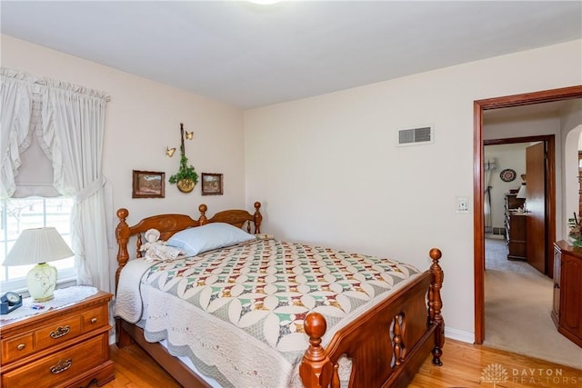 bedroom featuring visible vents and light wood-style flooring