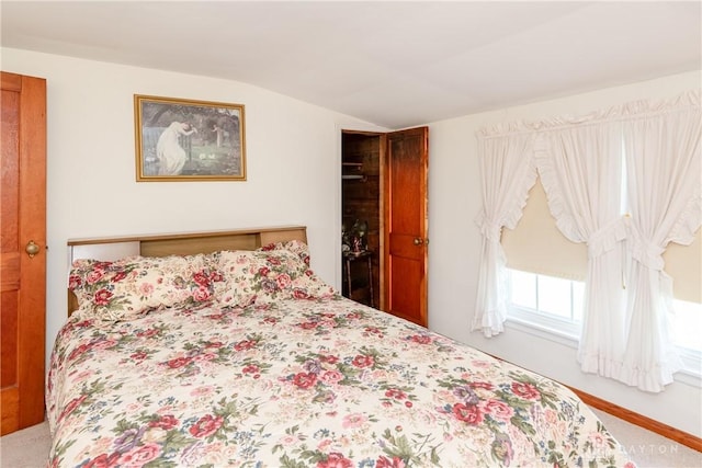 bedroom with carpet flooring and vaulted ceiling