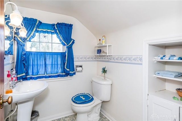 bathroom featuring vaulted ceiling and toilet