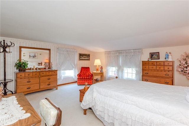 bedroom featuring light colored carpet and wallpapered walls