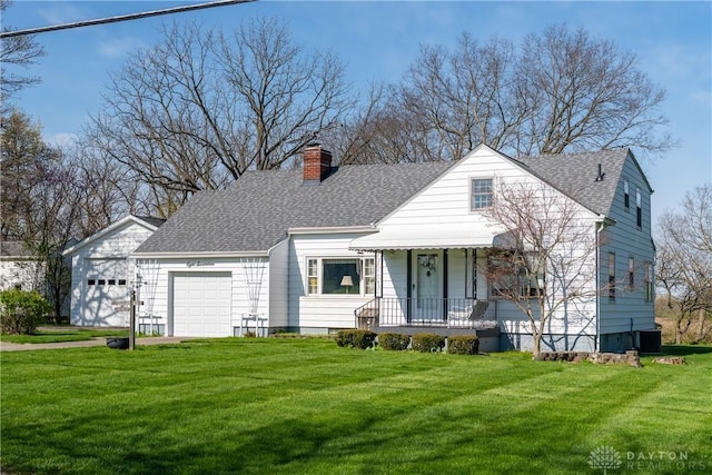 view of front of home with a chimney, a front lawn, roof with shingles, and a garage