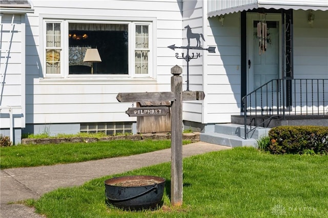 entrance to property with a lawn
