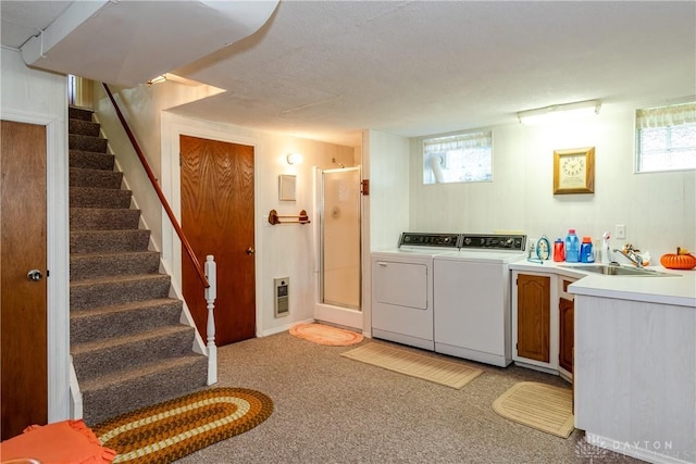 laundry room featuring a sink, washing machine and dryer, and light colored carpet