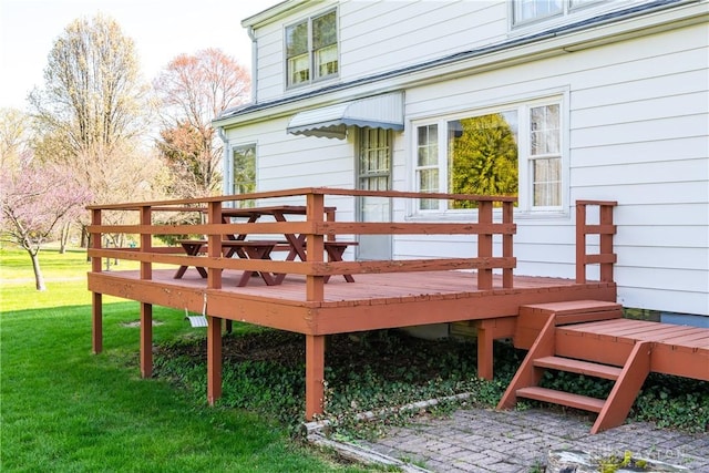wooden deck with a lawn