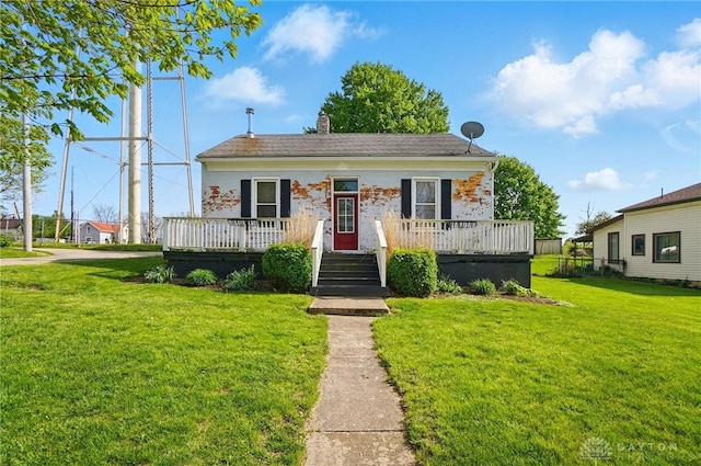 bungalow-style house with a chimney and a front yard