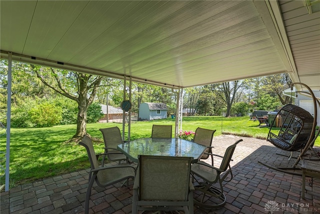 4600 Wing View Ln, Kettering, OH 45429 - view of patio with outdoor dining area and an outbuilding
