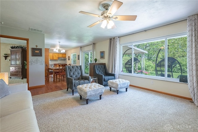 4600 Wing View Ln, Kettering, OH 45429 - carpeted living area with a ceiling fan, baseboards, a chandelier, and wood finished floors
