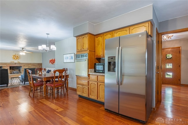 4600 Wing View Ln, Kettering, OH 45429 - kitchen featuring stainless steel fridge, oven, a chandelier, wood finished floors, and ceiling fan