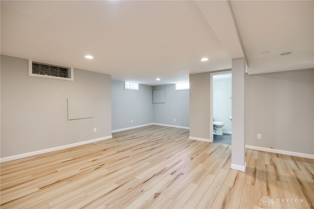 below grade area with recessed lighting, baseboards, and light wood finished floors