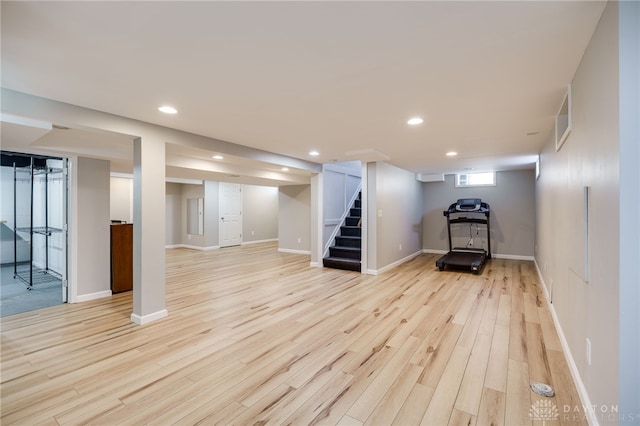 below grade area featuring recessed lighting, stairway, visible vents, and light wood finished floors